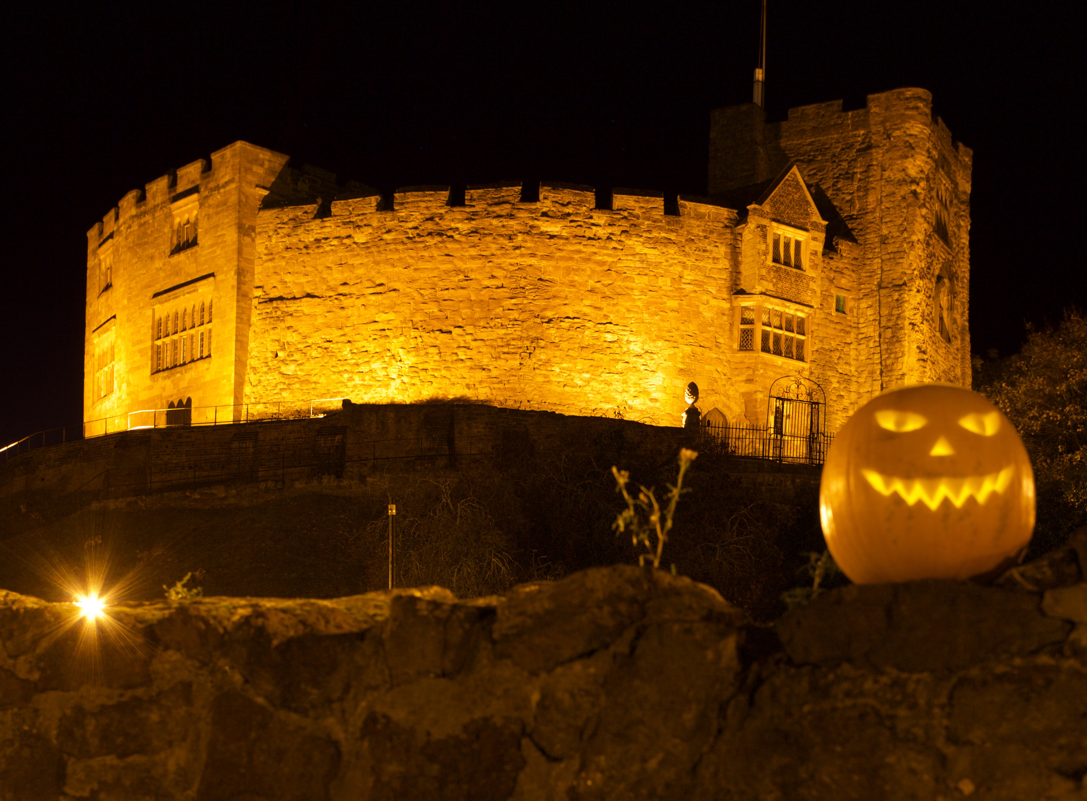 castle with yellow lighting and pumpkin
