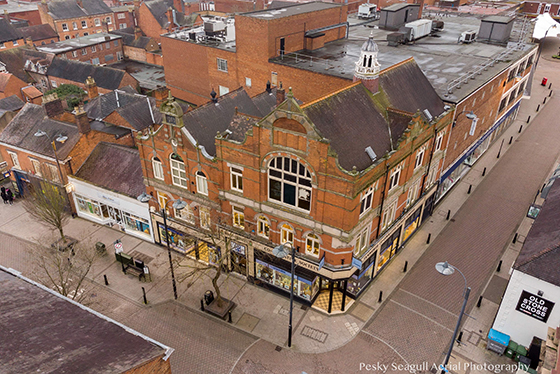 An aerial view of a buiding with a pointed roof
