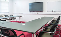 Large U-shape table with black chairs