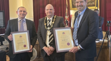 Tamworth's Mayor pictured with Rob Pritchard on the left and Danny Cook on the left holding up their alderman title awards in the town hall.