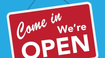 graphic with blue background and red sign saying come in we're open