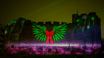 castle with outside projection on the wall and bright lights 