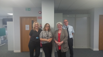 image if 4 people standing in an office